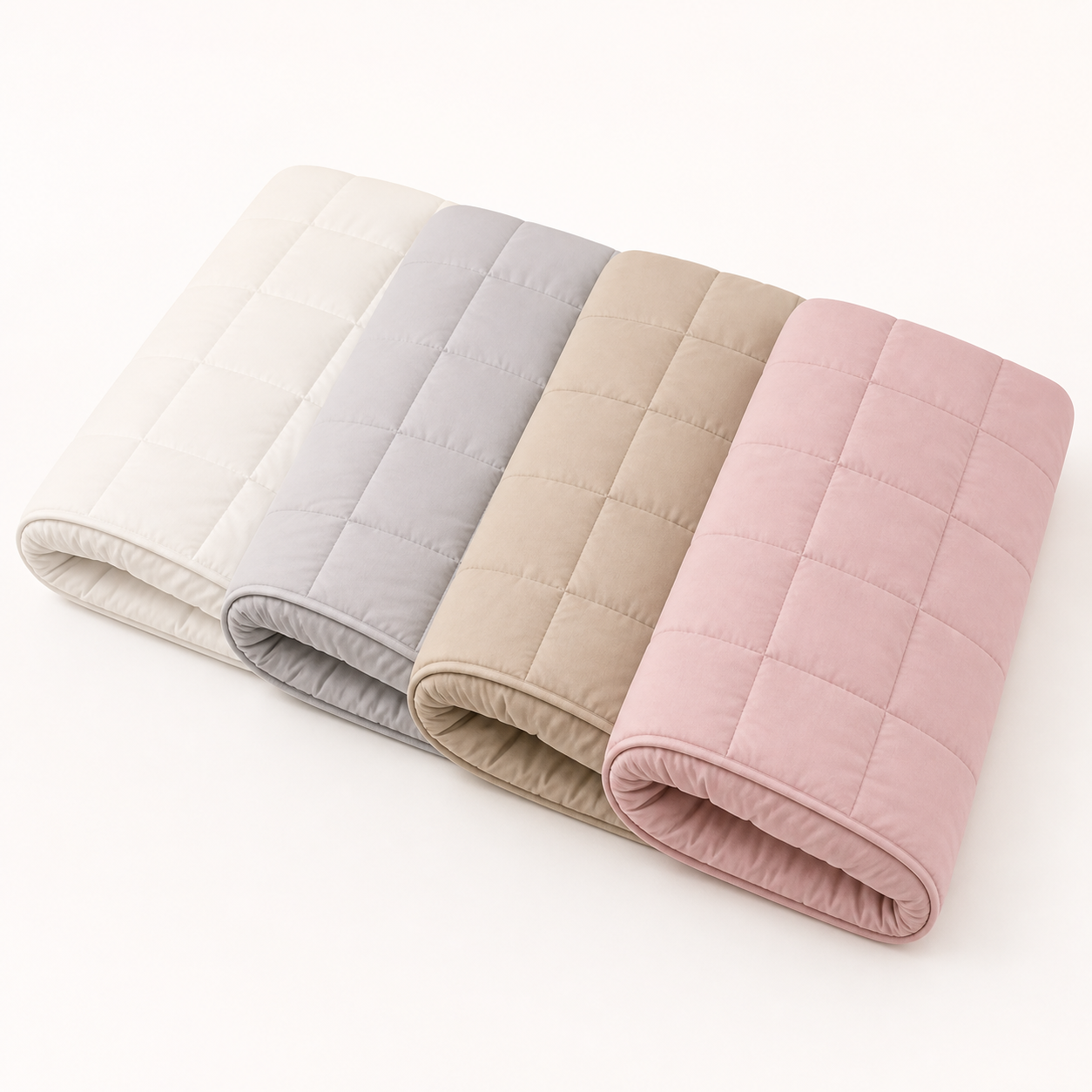 Four Xbound quilted mattress protectors in off white, soft gray, light khaki, and dusty pink